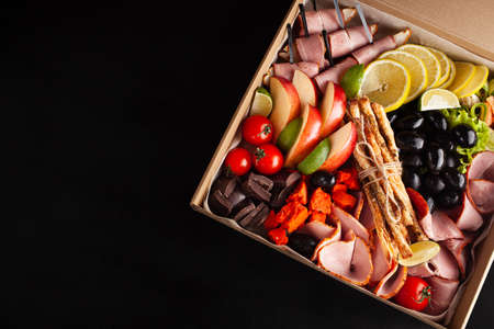 Gastronomic boxing, home delivery. Catering. Empty space for text, a gift for February 23, a birthday for a man. foodの写真素材