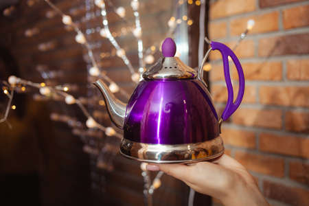 Teapot in tea shop, beautiful goods in womens hands. violetの写真素材