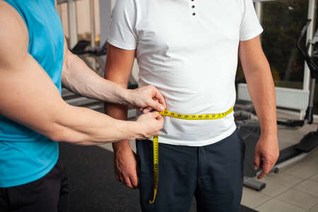 The trainer measures with a centimeter tape, in inches, body size. Weight loss result, classes in...