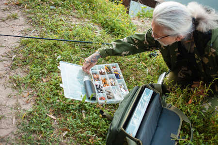 Fishing gear in the organizer, box. Various baits for predatory fish. Artificial fish for hook....