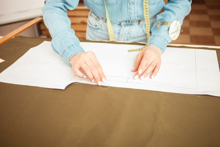 Seamstresses make sketch, pattern on fabric. Atelier, tailoring of individual clothes, small...