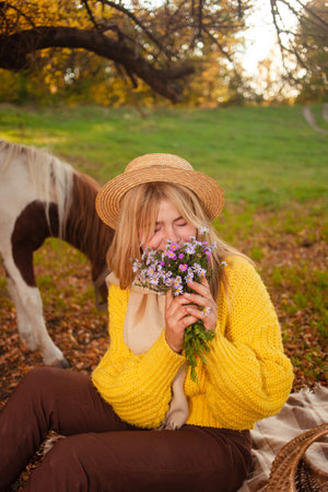 Beautiful screensaver, background, autumn forest, woman and pony in nature, concept of love, peace and goodness. posyの写真素材