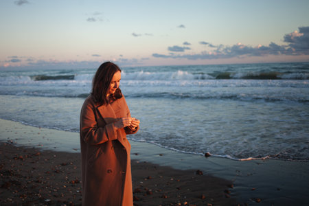 Woman walks on sand at twilightの写真素材