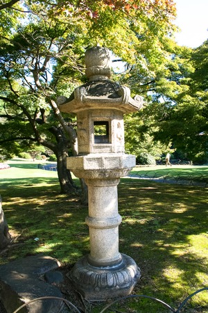 ancient oriental stone lamp in the gardenの写真素材