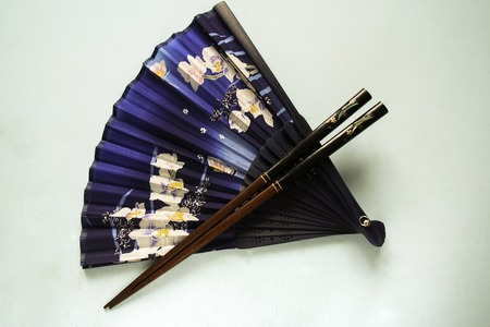 Blue fan with flowers and japanese chopsticksの写真素材