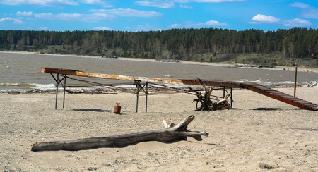Old broken pier on the lake shoreの写真素材