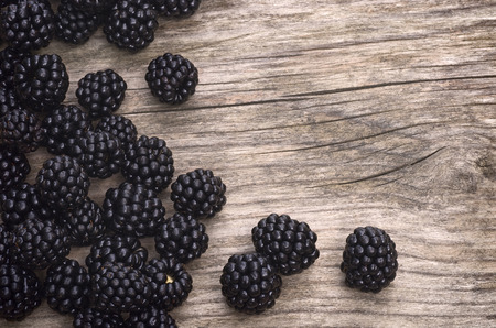 background for titles with blackberries and wood tableの写真素材