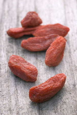 dry red goji berries (Lycium barbarum) on wooden tableの写真素材