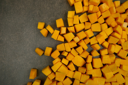Pumpkin cubes on stone background. Pumpkins cubes arranged in right side.の写真素材