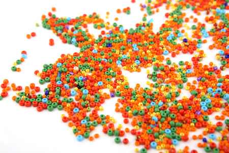 Colorful beads on white background. Abstract glass jewellery beads pattern.