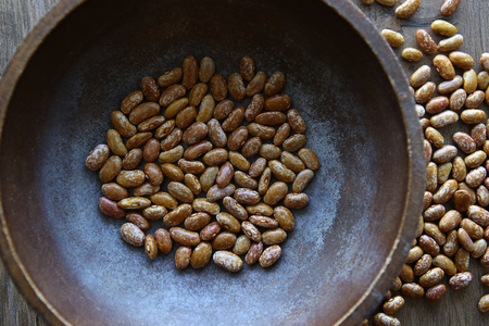 Pinto beans in bowl. Orange dried pinto beans.