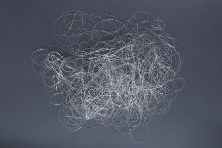 Silver thread pile like cloud. Pile of silver thread on grey background.