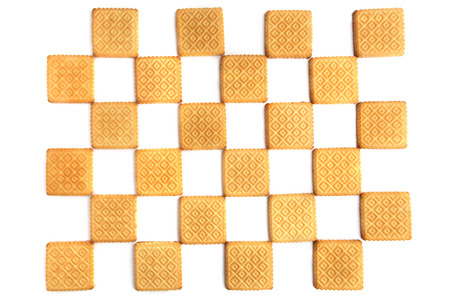 Checkered cookies background. Scuare biscuit isolated on white background.