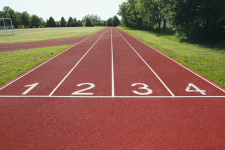 Numbered start track in stadium. Start line with numbers and lanes on running track in school...