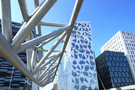 Oslo, Norway - July 19, 2018: Close up view of the Akrobaten pedestrian bridge in Bjorvika district. Modern business architecture in the center of Oslo. Fragment of the bridge across the tracks of the Oslo central station.のeditorial素材