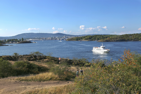 Oslo, Norway - July 19, 2018: View to the Oslo Fjord. Ferry boat sailing from the city center to the islands of the Oslofjord. Landscape view from island.のeditorial素材