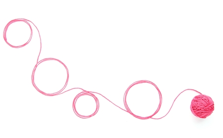 Abstract background with cotton thread. Circles of pink thread isolated on white background.