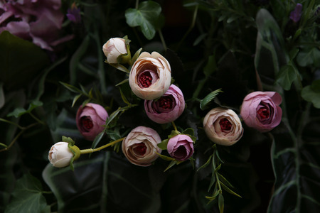 Close up of beautiful artificial flowers peonies. Plastic realistic flowers and plants wall background.の写真素材