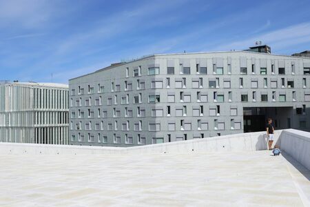 Oslo, Norway â€“ July 22, 2019: Rooftop of Oslo Opera House and view of modern buildings....
