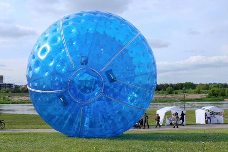 Two big blue  zorbing ball in park. Big plastic bubble in grass field.の写真素材