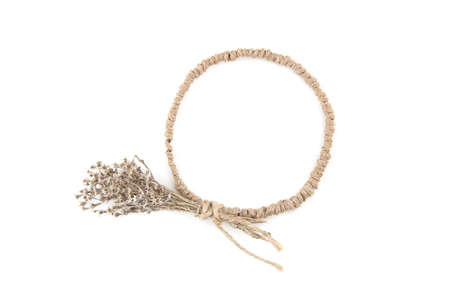 Circle frame of jute with dried grasses moss isolated on white background. Wild herbs or flowers...