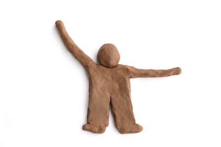 Figurine of natural clay  isolated on white background.  Doll man of wet clay material for sculpting...