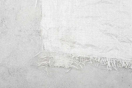 White woven plastic bag texture on stone background.  Crumpled polypropylene sack cloth surface on...