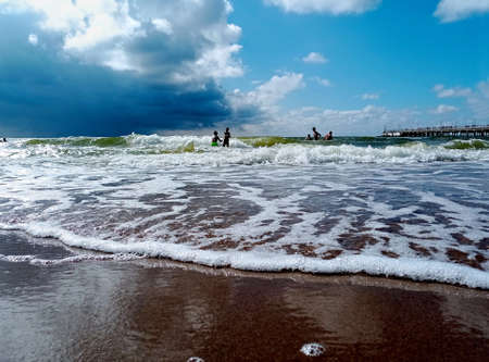 Baltic sea in summer time. Children swimming in the waves.の写真素材