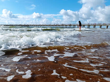 Baltic sea in summer time. Waving sea and Palanga bridge in horizon.の写真素材