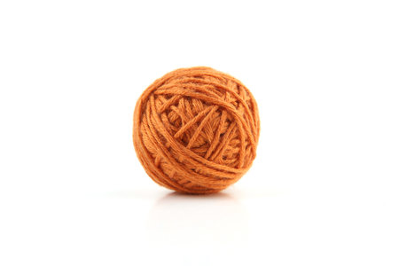 Orange cotton thread ball isolated on white background.の写真素材