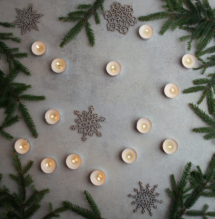 Candles and snowflakes decorations on stone background. Christmas composition. Christmas, winter, new year concept. Flat lay, top view, copy space.の写真素材