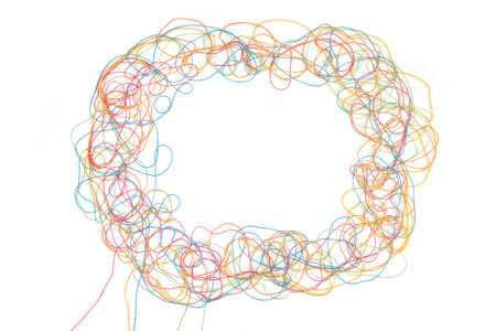 Frame of tangled colorful cotton threads isolated on white background. Abstract thread lines chaos...
