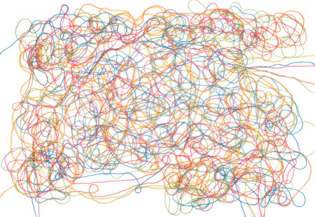 Tangled colorful cotton threads isolated on white background. Abstract thread lines chaos pattern.の写真素材