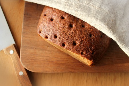 Freshly baked traditional bread on wooden table 