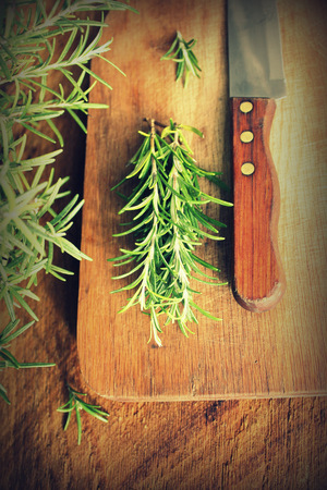 fresh rosemary on cutting boardの写真素材
