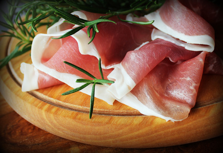 slices of ham on a cutting boardの写真素材