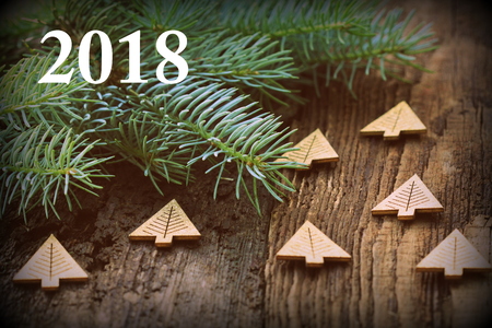 Frame from decorated Christmas tree on rustic wooden background with copy space for text. Happy New Year concept. Holiday background. Christmas mock-up or greeting cardの写真素材