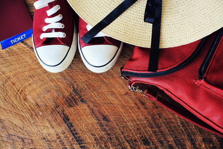 Women s summer outfit: red sneakers, backpack, hat . Traveling background and tourist stuffs. Top viewの写真素材