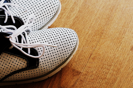 Pair of swhite shoes on wooden backgroundの写真素材