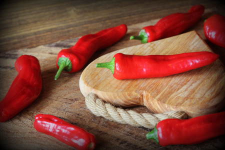 Fresh red peppers paprika on wooden background . Top view .の写真素材