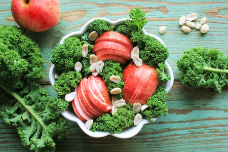 Salad with kale lettuce, apples, peanuts . Top viewの写真素材