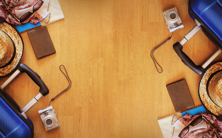 Suitcase and tourist stuff on wooden background .の写真素材