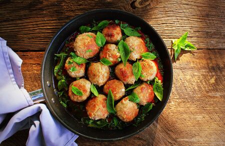 Meatballs in sweet and sour tomato sauce on rustic table. Top view .の写真素材