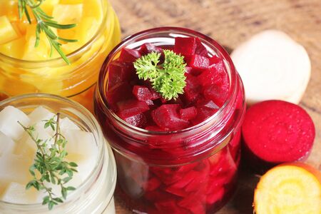 Pickled red, white, orange beet in glass jars.の写真素材