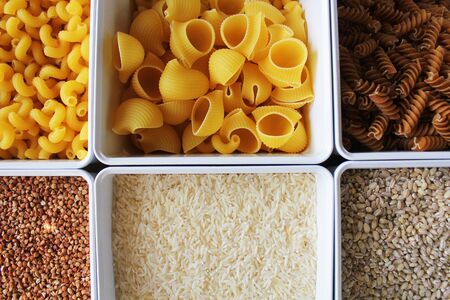 Rice, noodles, oats and buckwheat in a box. Food supplies