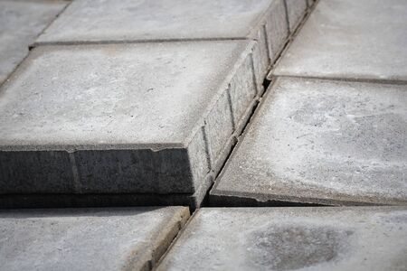 Stack of gray paving slabs. Construction of sidewalks. Building materials for the construction of...