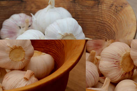 Garlic Cloves and Bulb in vintage wooden bowl.の写真素材