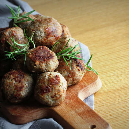 Roasted meatballs , delicious meat cutlets on wooden table . Top view .