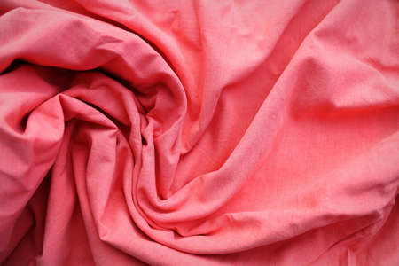 Rose gold fabric cloth texture for background and design art work, beautiful crumpled pattern of pink cottonの写真素材