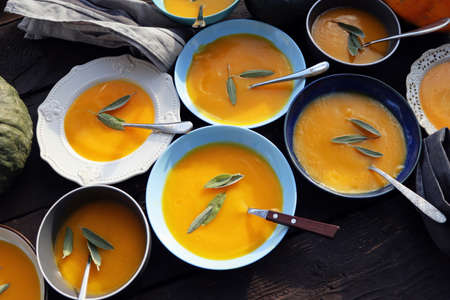 Thanksgiving concept with pumpkin, pumpkin soup .Fall table setting for celebration Autumn holiday with soup.の写真素材